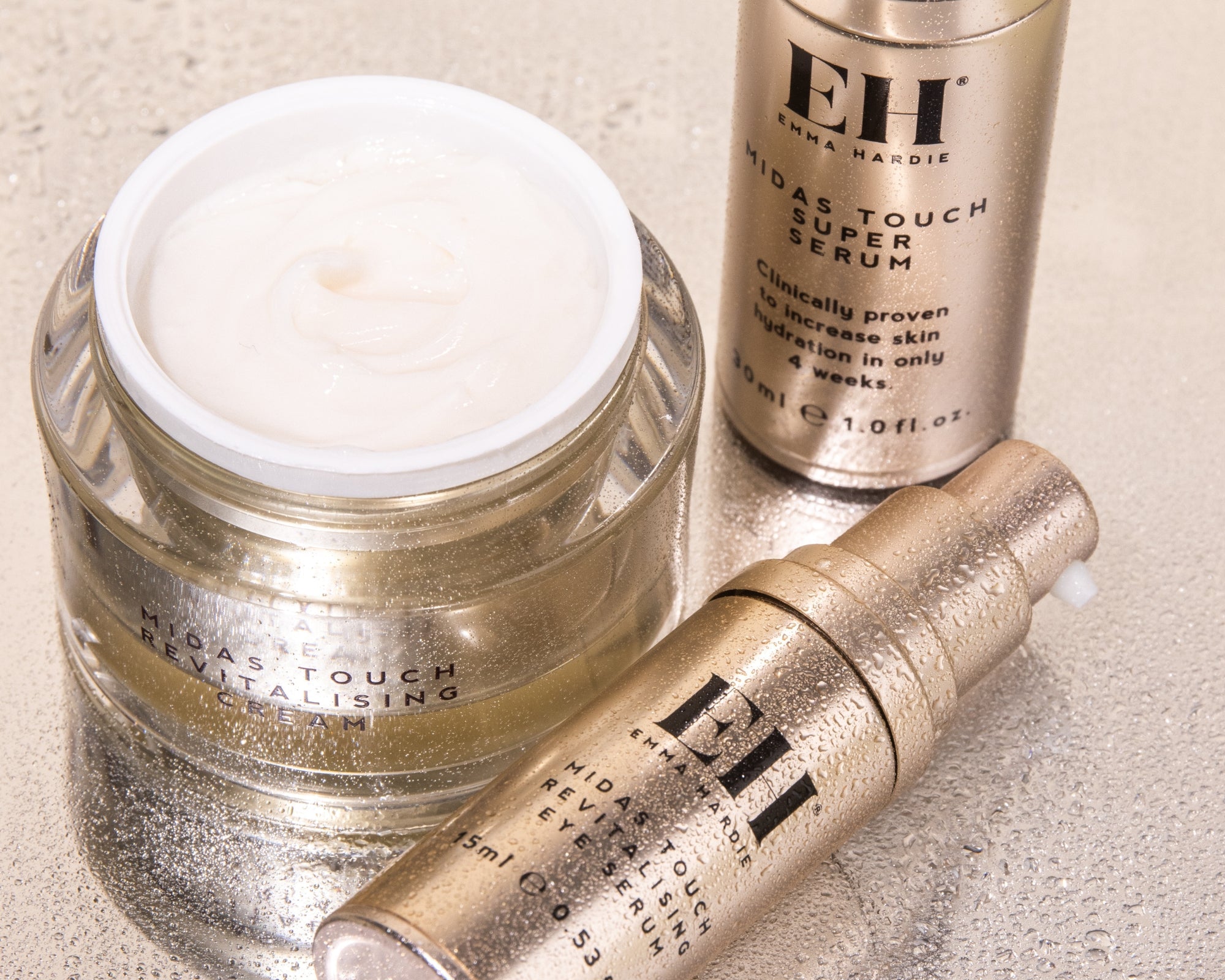 Emma Hardie Midas Touch Revitalising Cream, Super Serum and Revitalising Eye Serum arranged together with visible product textures.