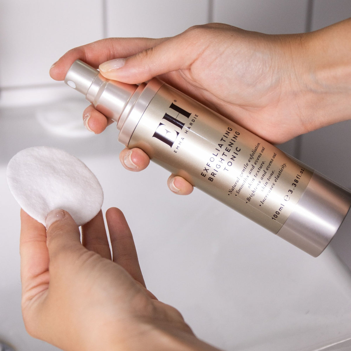 Emma Hardie Exfoliating Brightening Tonic being applied to cotton pads.