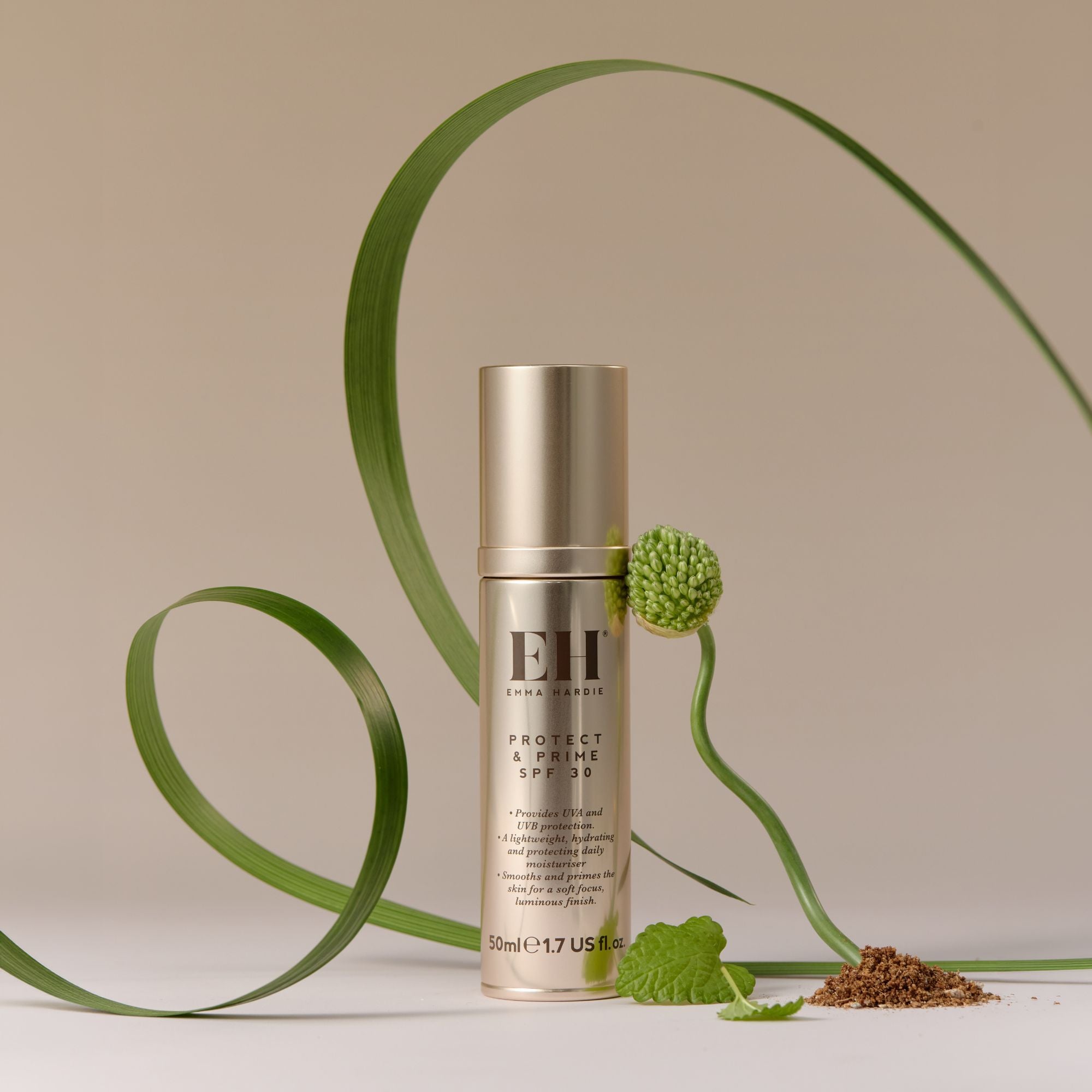 Emma Hardie Protect & Prime SPF30 bottle styled with green botanicals on a soft neutral background.