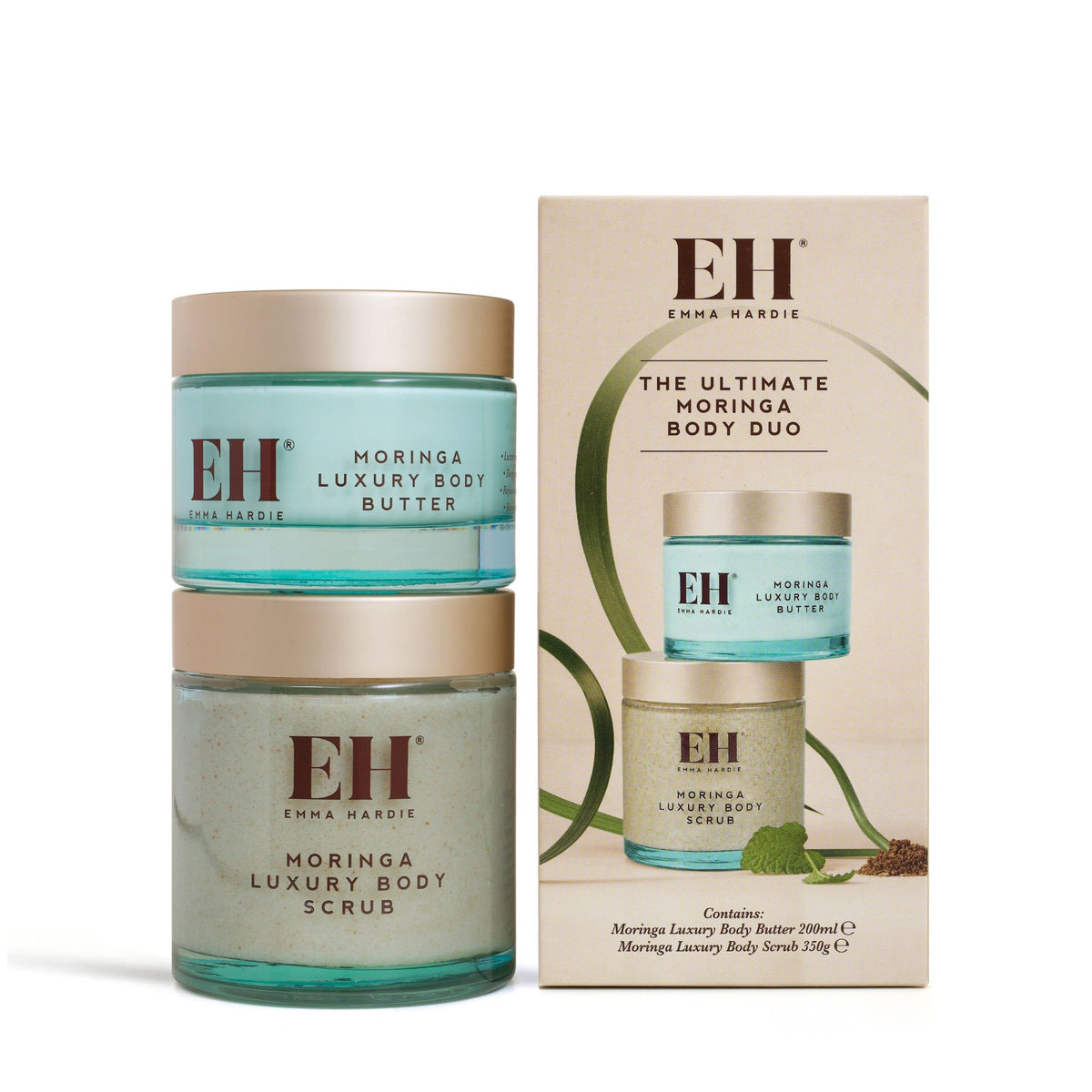 Emma Hardie Moringa Luxury Body Butter stacked on Moringa Luxury Body Scrub beside the Ultimate Moringa Body Duo gift box on a white background.
