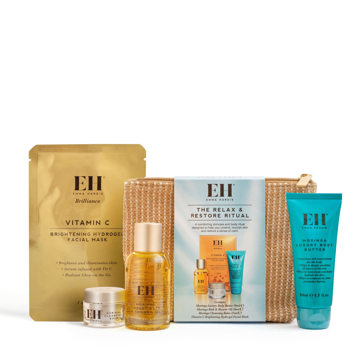 Emma Hardie Relax & Restore Ritual with cleansing balm, bath and shower oil, body butter and Vitamin C hydrogel mask beside a woven wash bag on a white background.