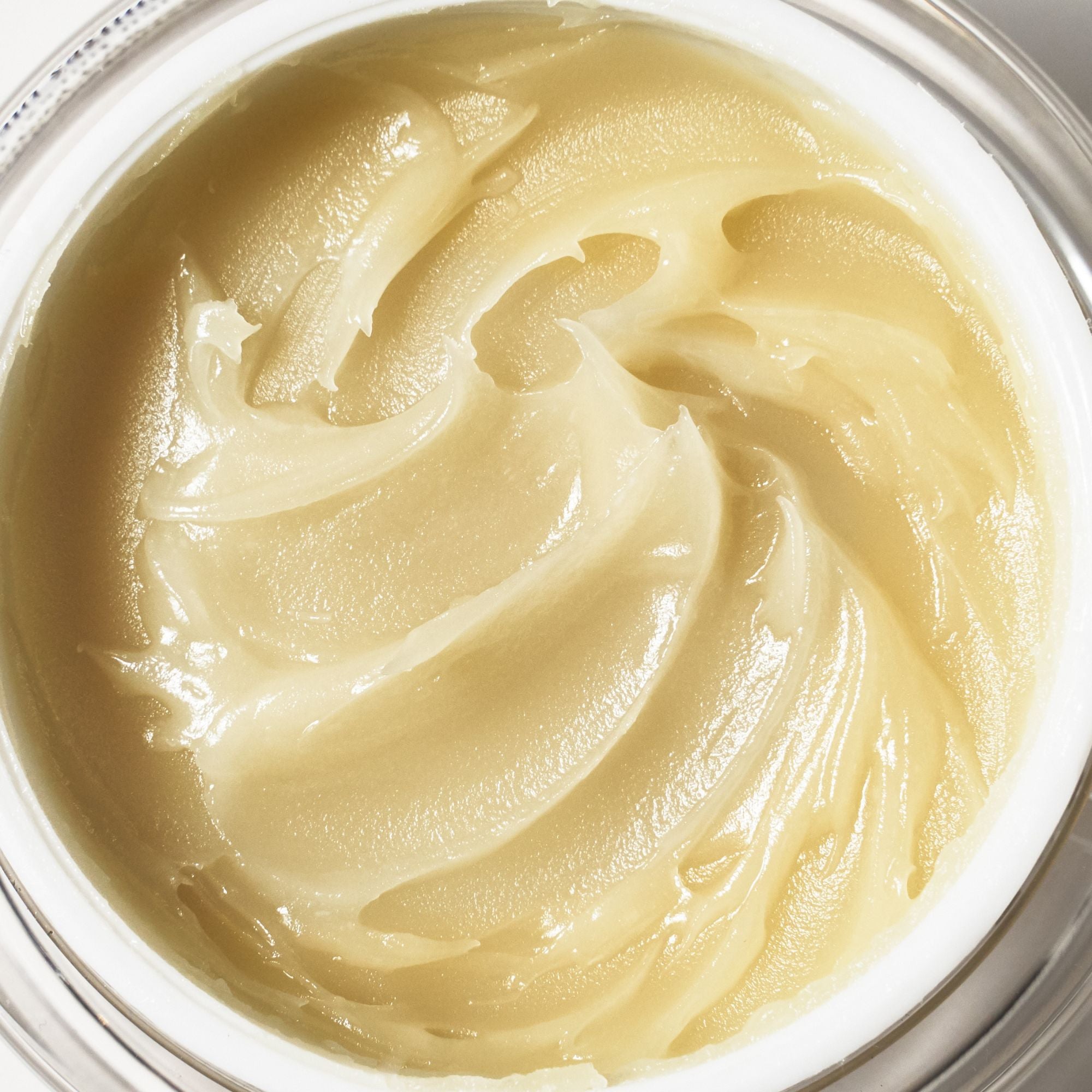 Close-up of the buttery texture of Emma Hardie Moringa Cleansing Balm, showing the rich balm surface in an open jar.