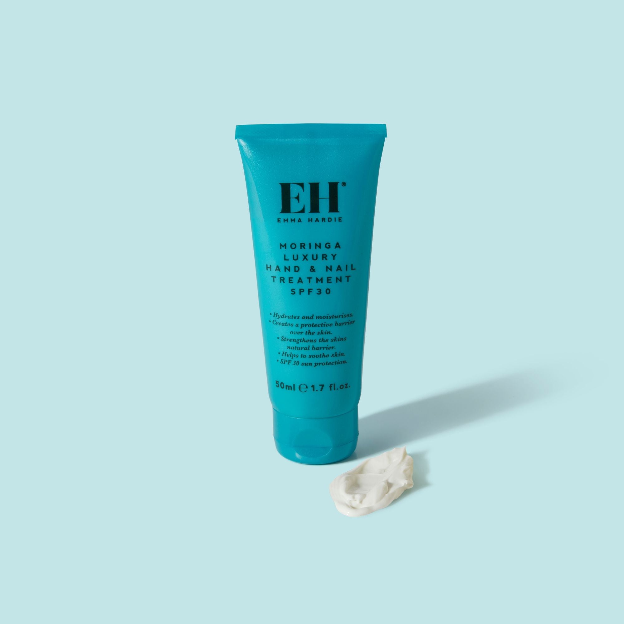 Tube of Emma Hardie Moringa Luxury Hand & Nail Treatment on a light blue background