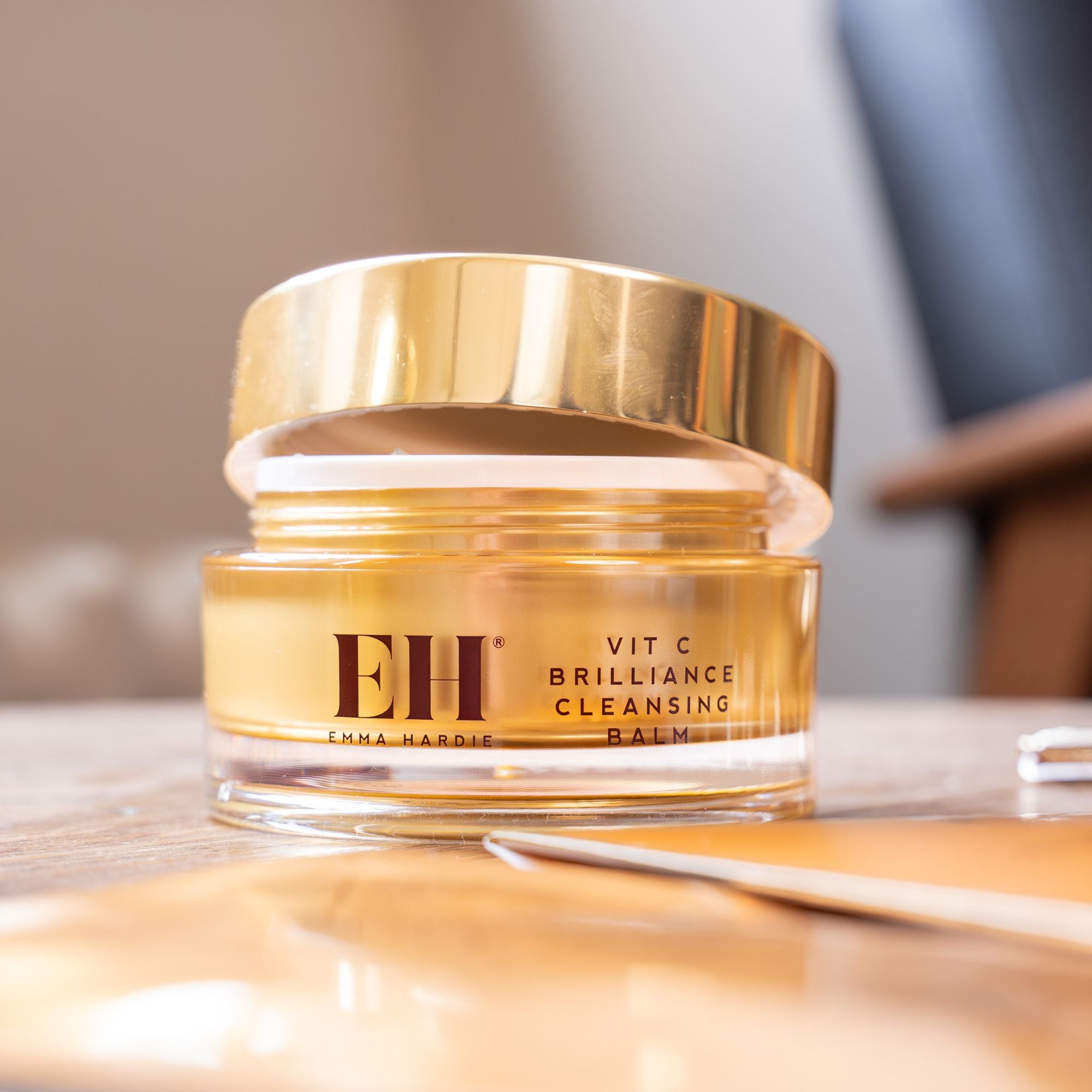 Jar of Emma Hardie Vit C Brilliance Cleansing Balm on a reflective surface