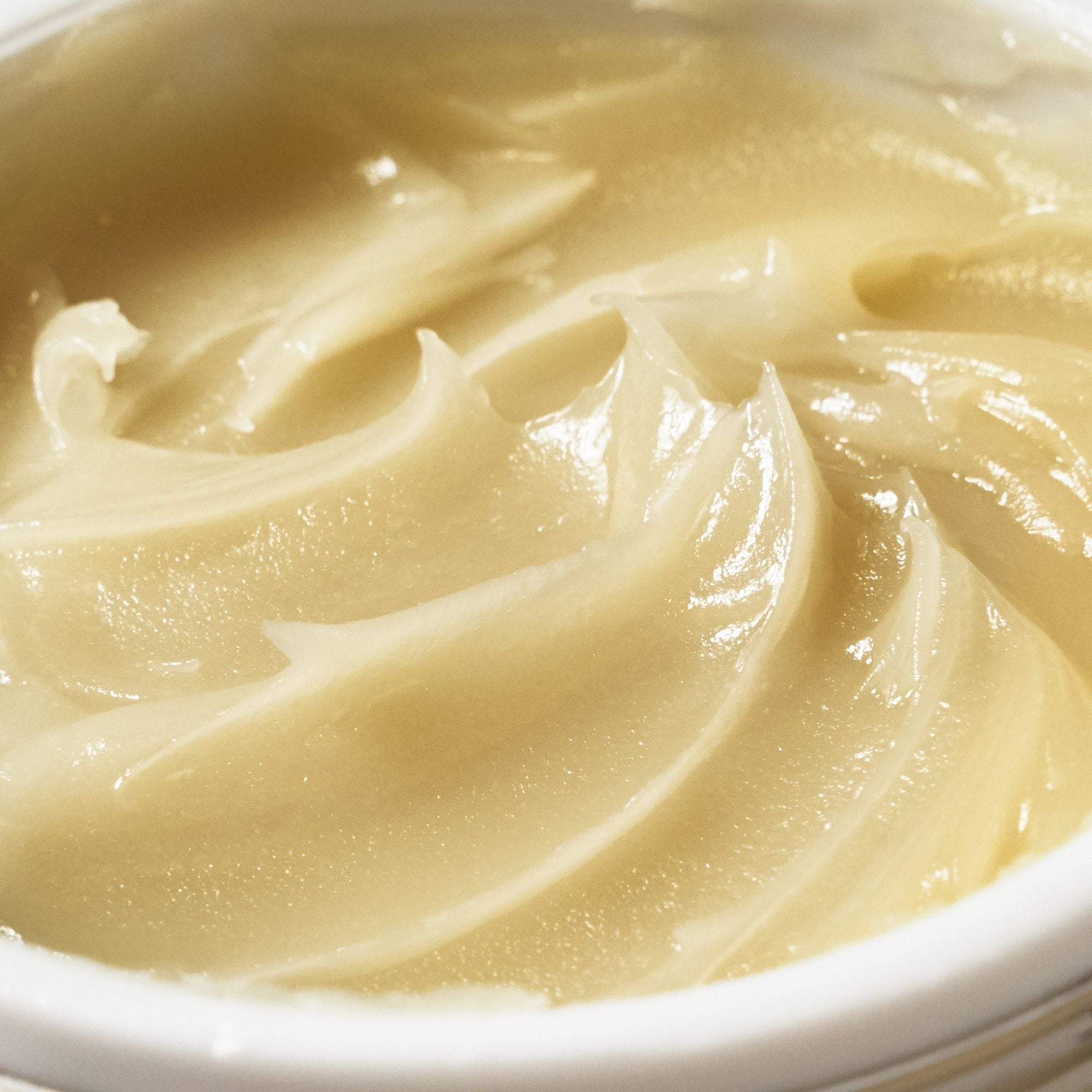 Close-up of the buttery texture of Emma Hardie Moringa Cleansing Balm, showing the rich balm surface in an open jar.