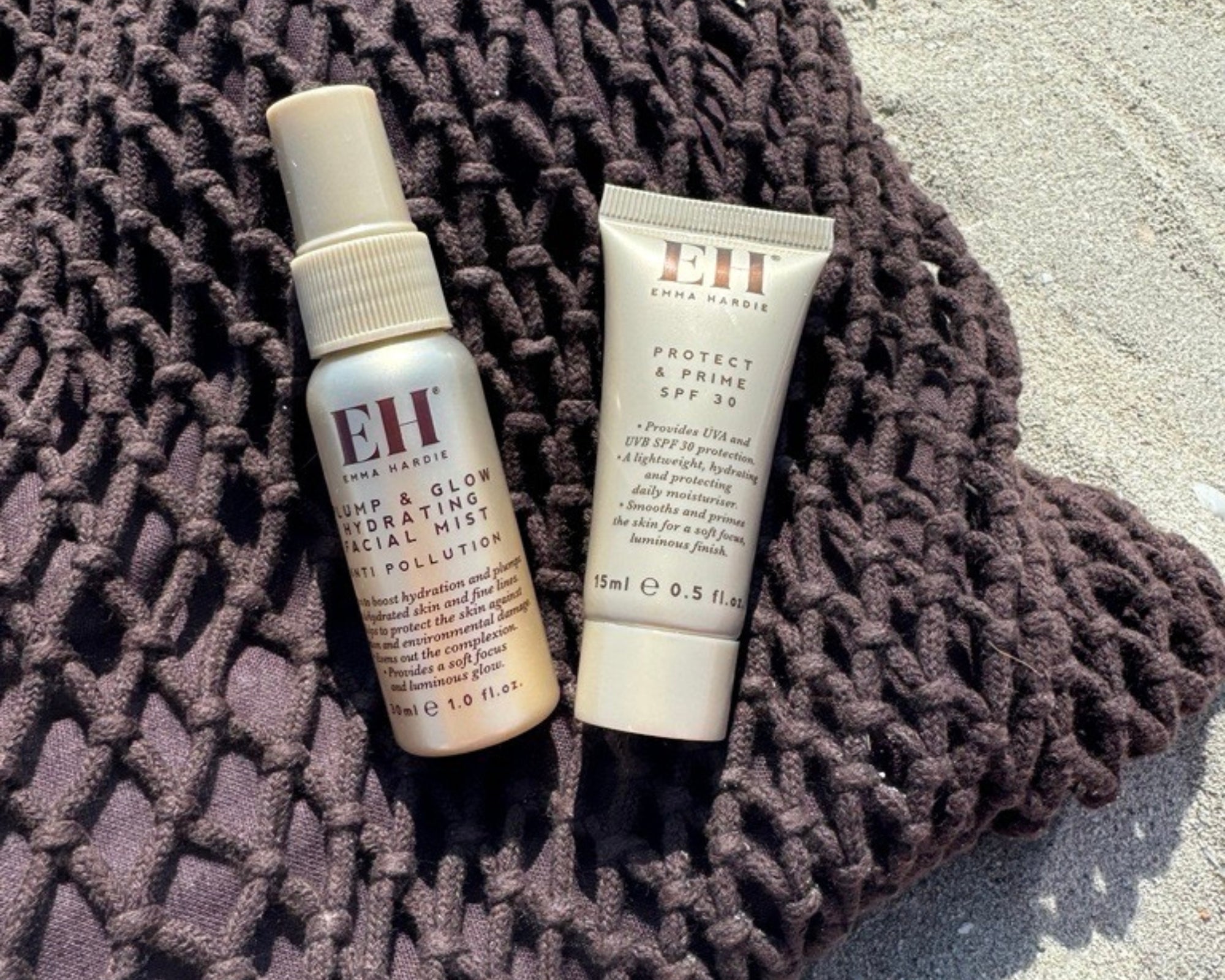 Emma Hardie Plump & Glow Hydrating Facial Mist and Protect & Prime SPF30 on a textured summer towel.