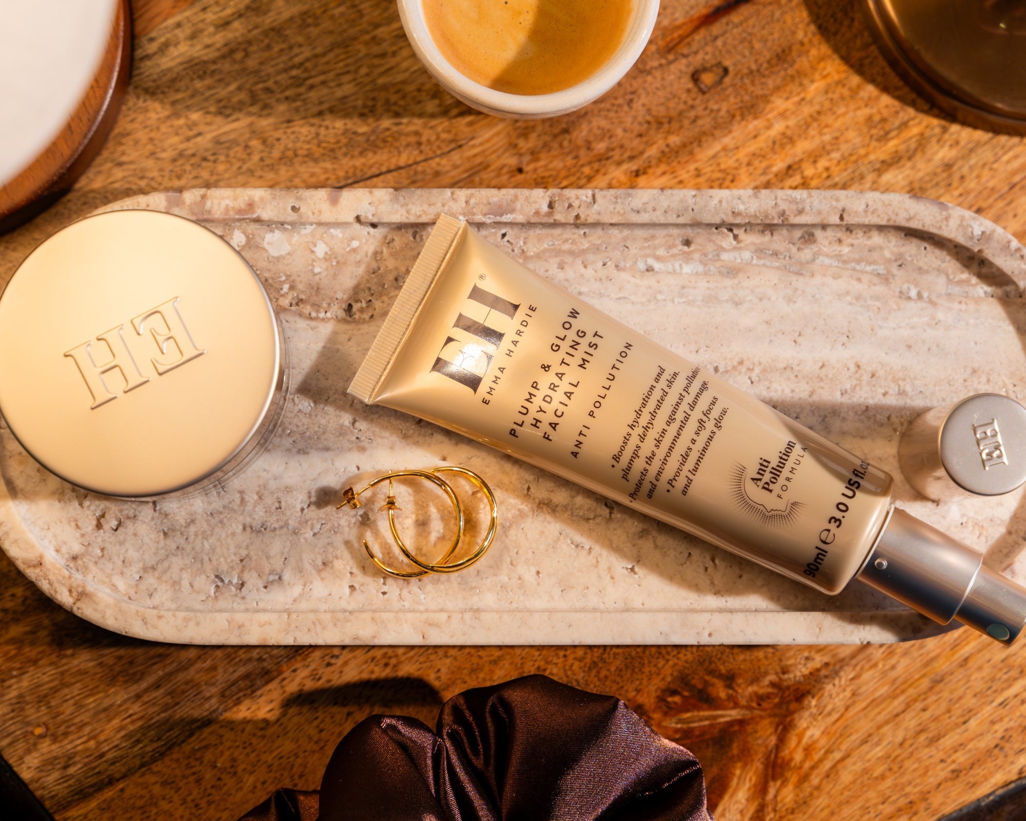 Emma Hardie Plump & Glow Hydrating Facial Mist displayed on a stone tray with skincare accessories.