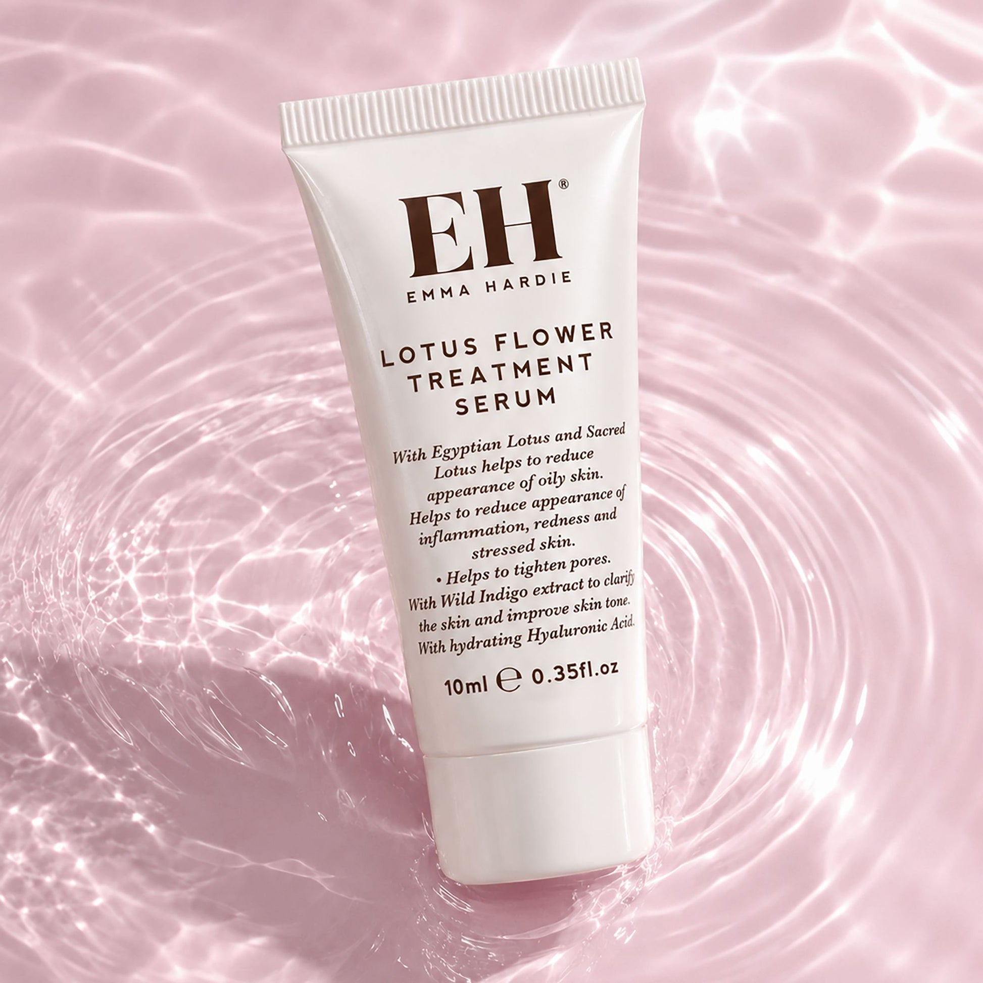 Tube of Emma Hardie Lotus Flower Treatment Serum on a pink water background