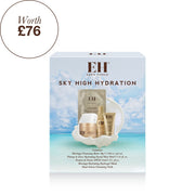 Emma Hardie Sky High Hydration skincare set in its retail box, featuring a light blue tropical beach background on the packaging with visible gold and white skincare items inside.