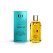 Bottle and box of Moringa Luxury Bath & Shower Oil with EH branding on a white background