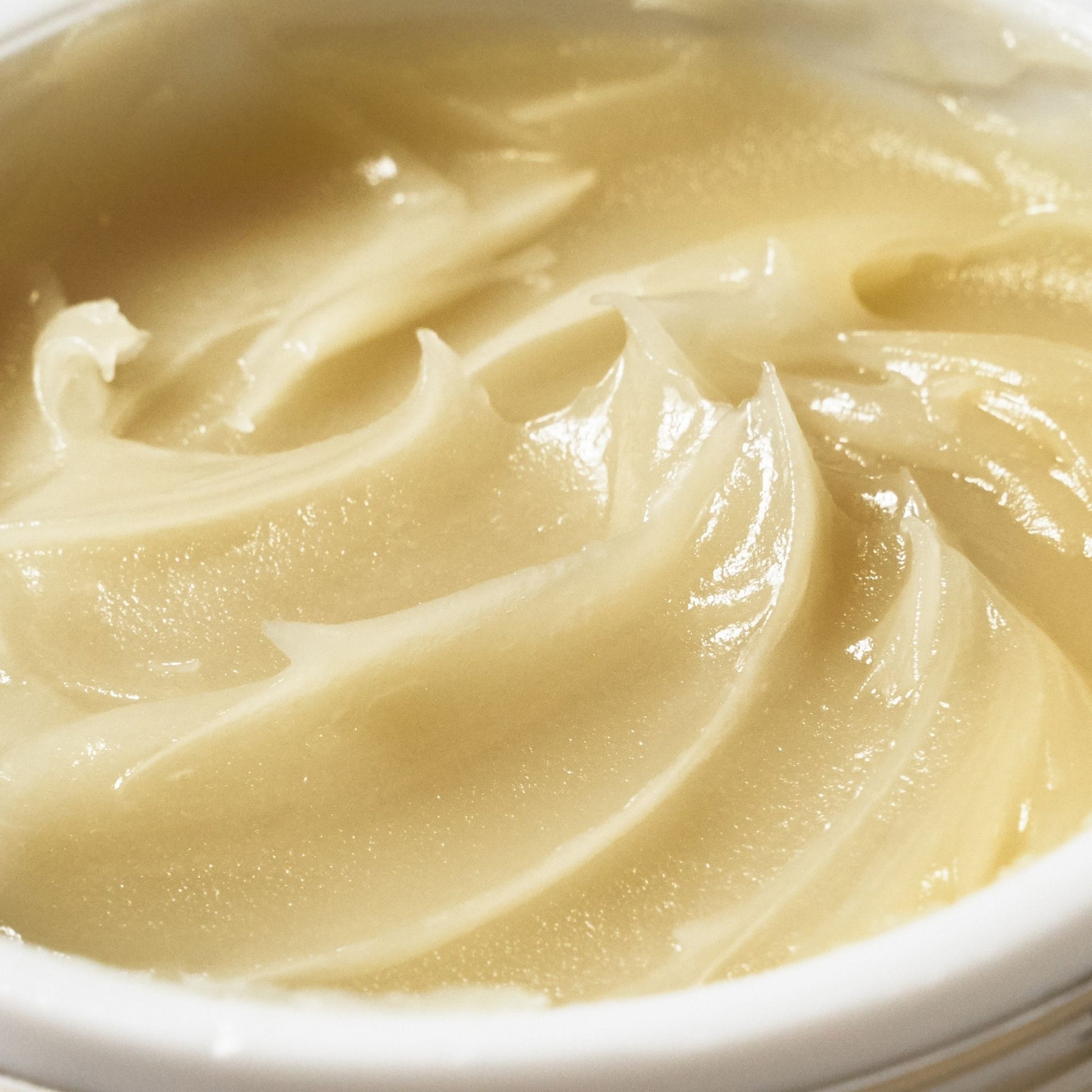 Close-up of the buttery texture of Emma Hardie Moringa Cleansing Balm, showing the rich balm surface in an open jar.