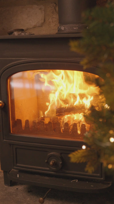 Emma Hardie skincare gifts nestled among Christmas tree branches, gold baubles and warm fairy lights.