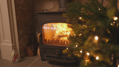 Emma Hardie skincare gifts nestled among Christmas tree branches, gold baubles and warm fairy lights.