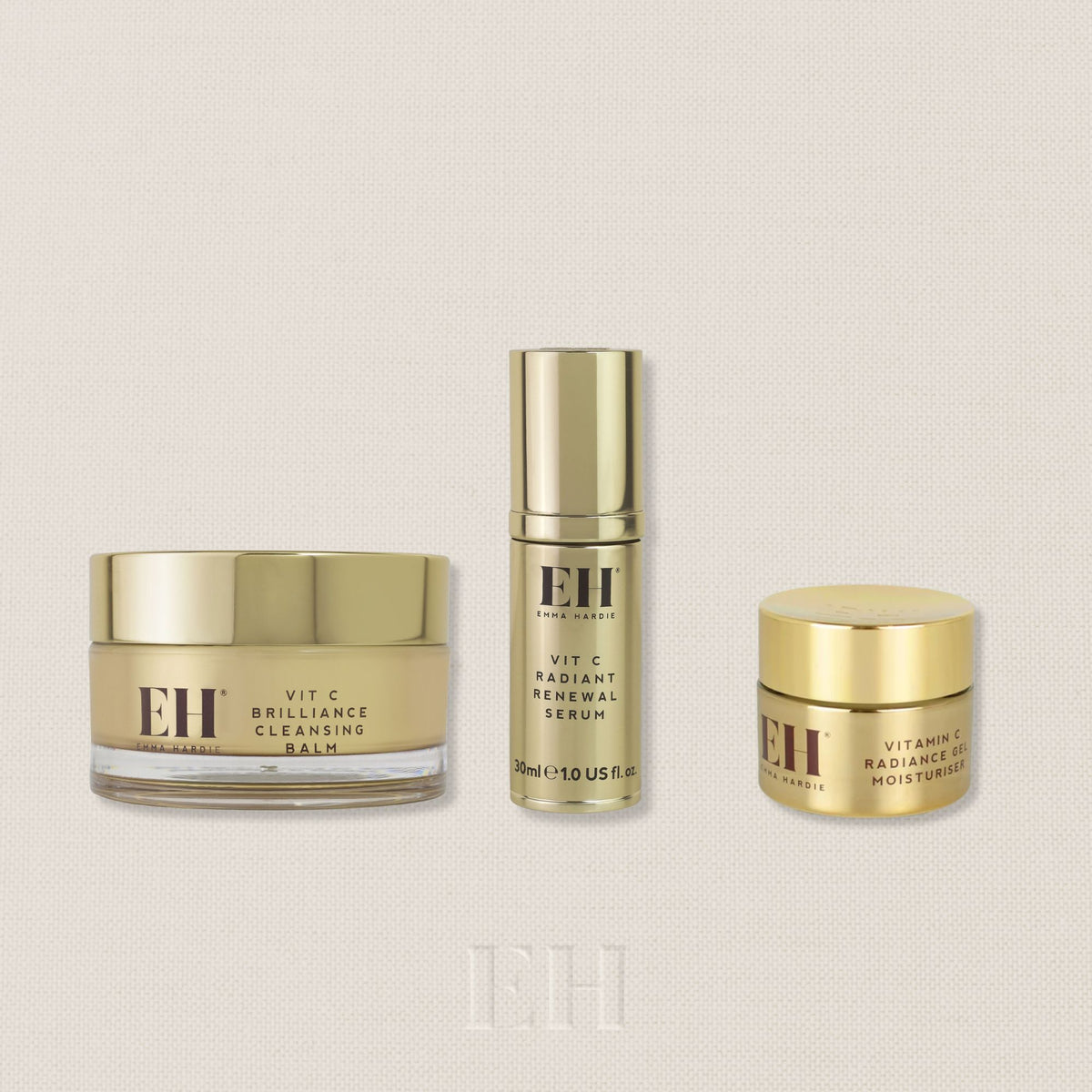Three Emma Hardie products from the Ready, Set, Glow Ritual Set: Vit Brilliance Cleansing Balm, Vit C Radiant Renewal Serum and Vitamin C Radiance Moisturiser with a  'Worth £170' roundel in the top right.